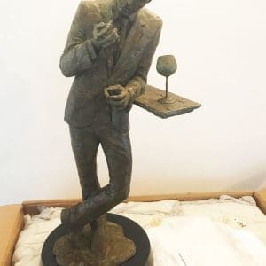 Bronze piece, man at bar in thought, timeless allure (front)